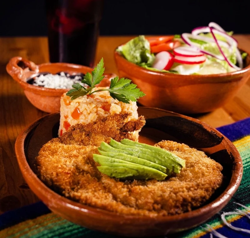 Milanesa de pollo, breaded chicken cutlet with avocado and Mexican rice at Casa Azul, St. Thomas
